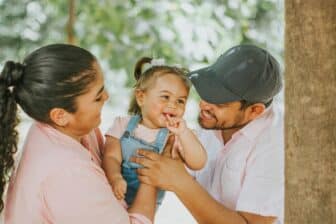 Mother and father holding looking lovingly at their child